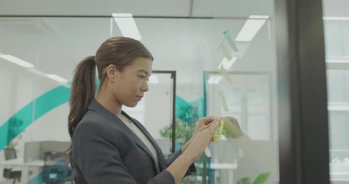 Business Woman in Office Contemplating on Strategy, Looking at Notes