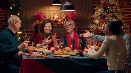 Family Celebrates Christmas Dinner Together with Video Call