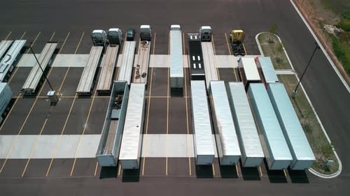Parking of Logistics Warehouse with Semi Trucks and Cargo Trailers Aerial View