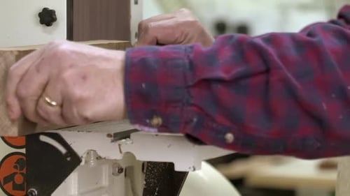 A Carpenter using a sander in a furniture factory in slow motion