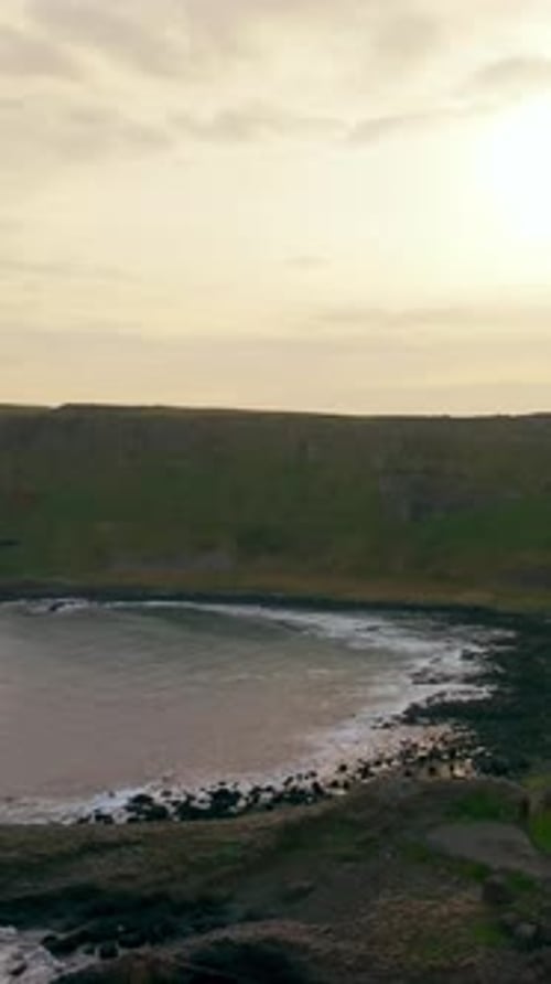 Reversing sunrise social ratio aerial video of The Giant's Causeway in Bushmills, Northern Ireland