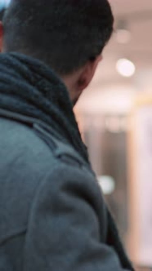 Woman Giving Christmas Gift to a Man in Retail Setting