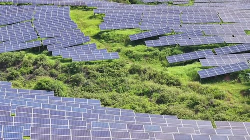 Solar Panels on Lush Green Hillside, Aerial