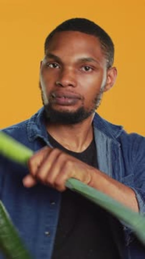 Man Spins Vegetables With Intensity and Bites Cucumber