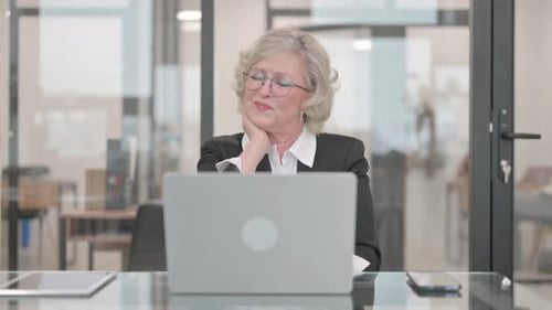 Business Woman Experiencing Neck Pain at Desk