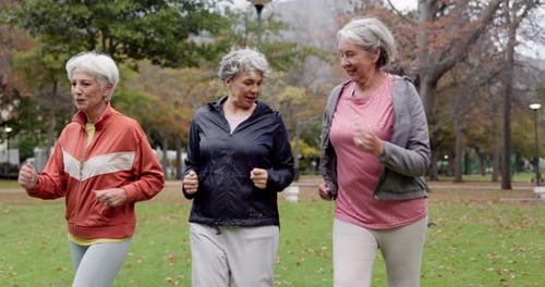 Smiling Senior Women Exercising in an Urban Park