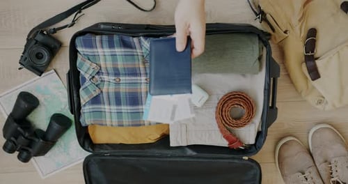Packing Suitcase with Travel Essentials, Overhead