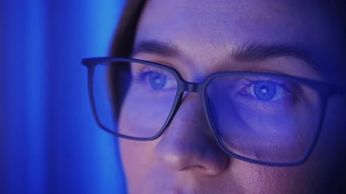 Businesswoman Working at Night Looking at Monitor Reflections in Glasses Personal Stock Market