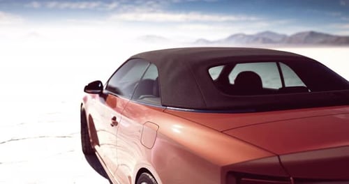 Modern Convertible Car Driving Through a Vast Desert Landscape