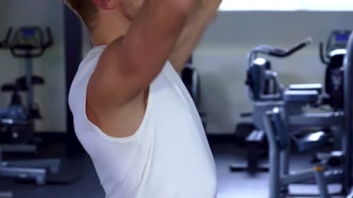 Determined Man Powerlifting a Barbell at the Gym