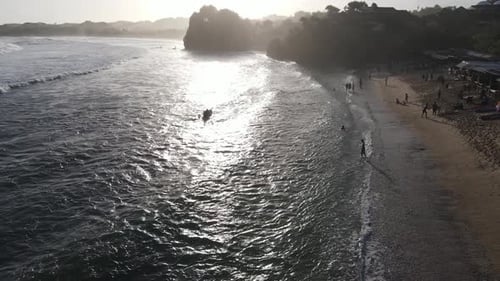 Aerial view of beautiful sunset at Beach in Indonesia with yellow sunny day.