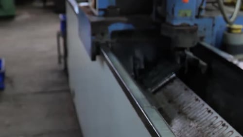 Machine Putting Oil on Metal Blade in Factory
