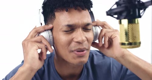 Singing, studio and a man with a microphone on a white background for sound production