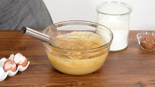 Adding Flour to Batter in Glass Bowl
