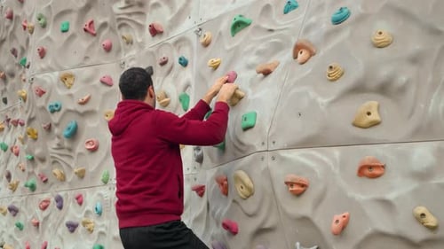 Man Climbing Indoor Rock Wall for Fitness