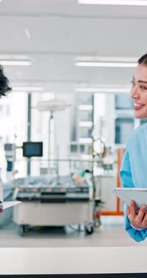 Medical Professionals with Tablets in Modern Hospital Setting