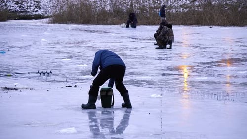 winter fishing on a frozen lake many people fishing on the ice