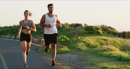 Athletic Couple Jogging on Scenic Road Together