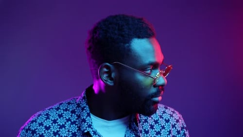 An EyeCatching Stylish Portrait of a Man Captured in Neon Lighting Featuring Trendy Glasses