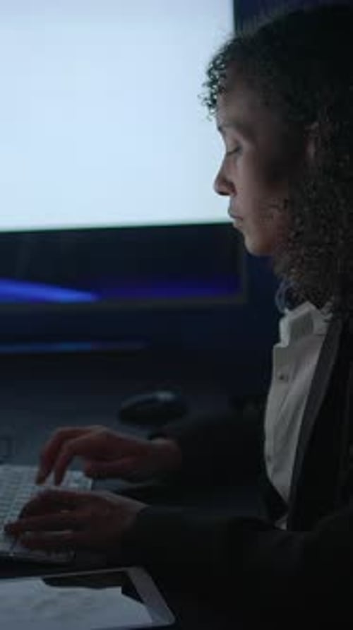 A Professional Expert Working Diligently on a Computer with Focused Digital Data Analysis