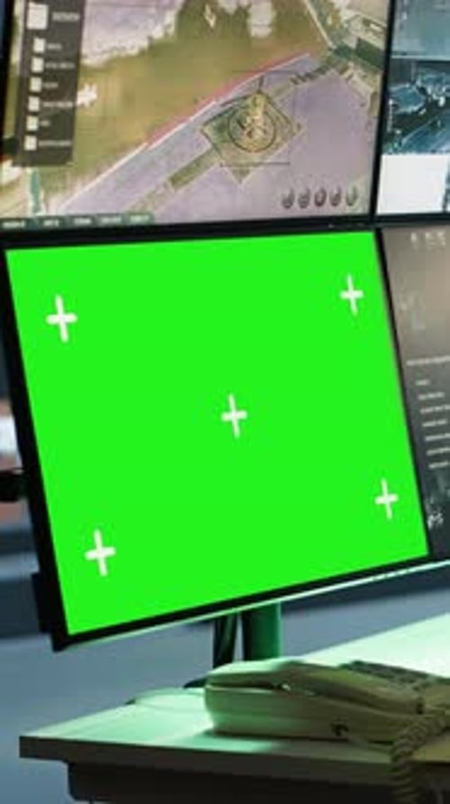 Vertical Video Special Forces Spy Examining Data in Monitoring Room with Chroma Key Monitors