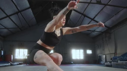Woman Balances on Bosu Ball in Gym