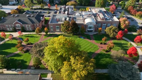 Academic college campus buildings at university in USA. Aerial truck shot of common grounds.