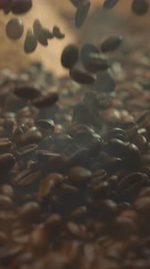 Super Slow Motion Shot of Falling Roasted Coffee Beans with Smoke in Macro Vertical Close Up Video