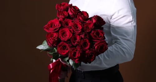 Man in Suit Holding Red Rose Bouquet Close Up