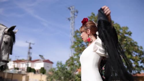 Spanish Flamenco Dancer Posing with a Beautiful Gray Horse