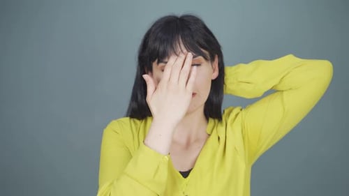 Woman Experiencing Headache, Touching Head in Discomfort