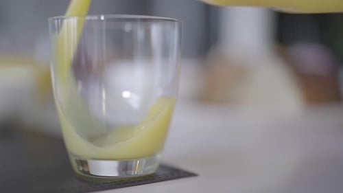 Refreshing Orange Juice Being Poured into Glass