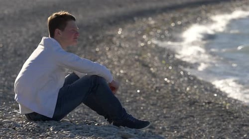 sad boy by the lake alone contemplates the landscape thinking