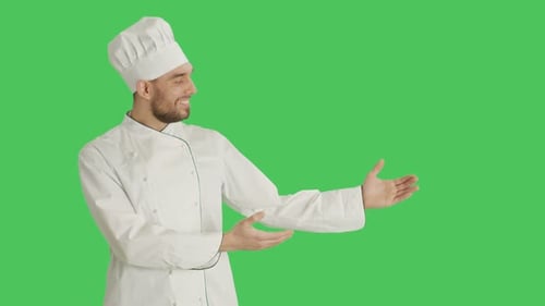 Mid Shot of a Handsome Chef making Presenting Gesture. Background is Green Screen.