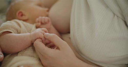 Mother lovingly breastfeeding her baby in peaceful home