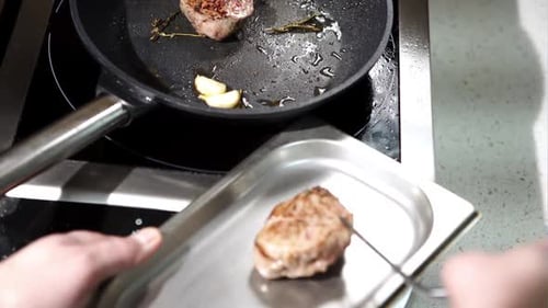 A Man Preparing Beef Steak in a Frying Pan