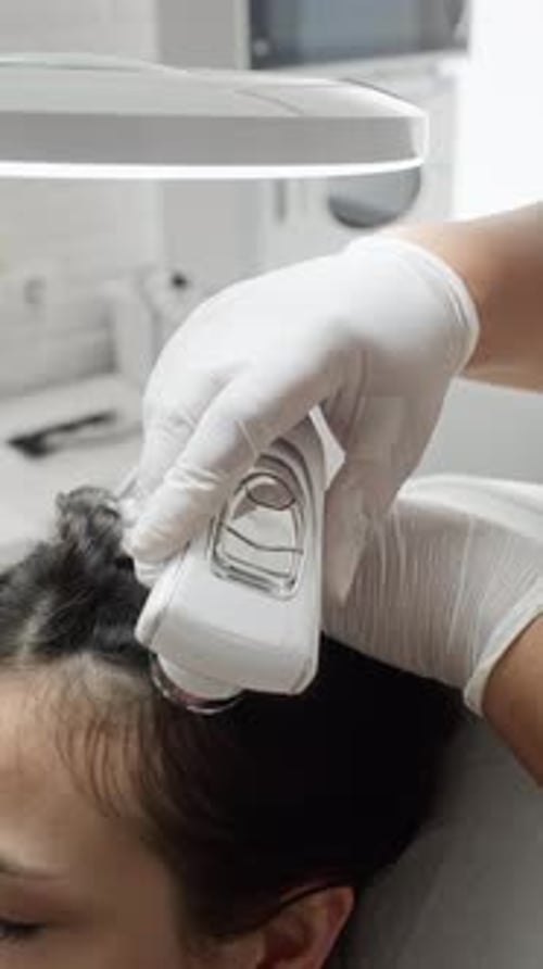 Woman Receiving Scalp Treatment with Modern Trichology Device