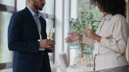 Business Professionals Shaking Hands with Champagne at Event