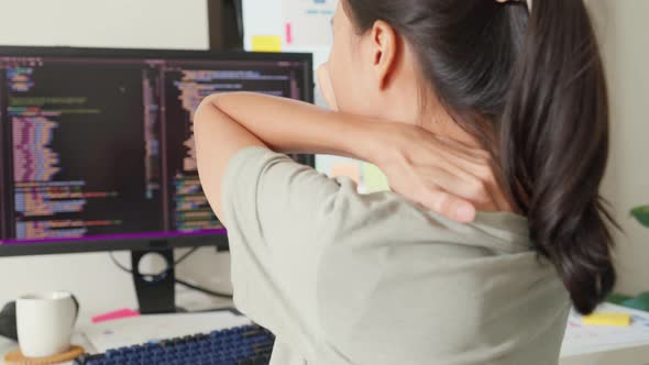 Asia girl developer programmer overwork tired painful shoulder neck ...