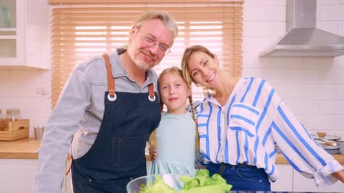 Portrait of attractive Caucasian family cook foods in kitchen at home.