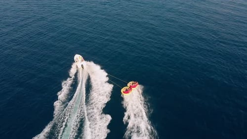 Speed Boat Pulls Yellow Inflatable Rubber Raft 01