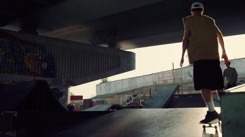 Teenagers Skateboarding and Riding Scooters in Urban Skatepark