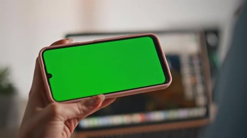 Woman Watching Content Green Screen Cellphone at Home Closeup Unknown Hands