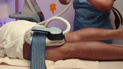Spa therapist EMS electro stimulation therapy on femoral legs muscle man male muscle muscular vibrat