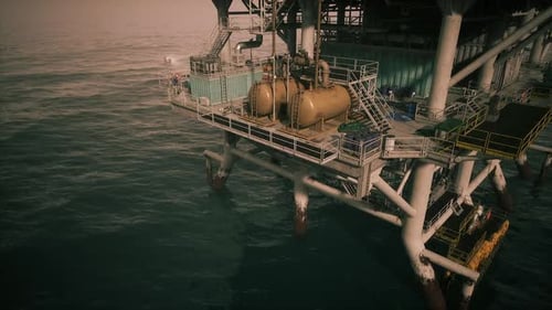 Oil Rig Platform Operating in Open Waters During Golden Hour Sunlight