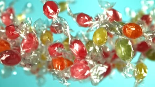 Colorful Wrapped Candies Floating Against a Blue Background