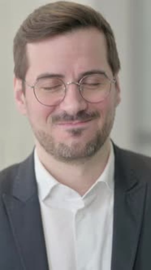 Man Smiling in Suit Wearing Glasses Close Up