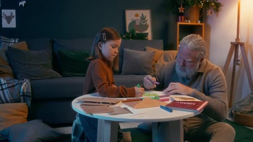 Grandfather and Grandchild Drawing Christmas Tree Together
