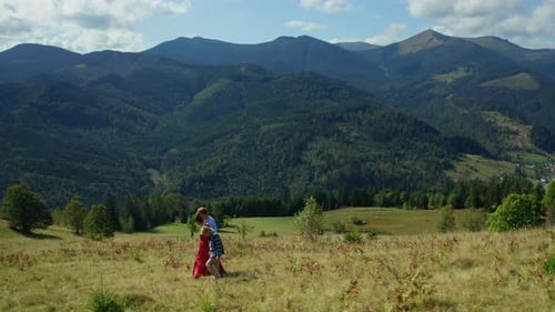 Family adventure walking through stunning mountain landscape on a summer day
