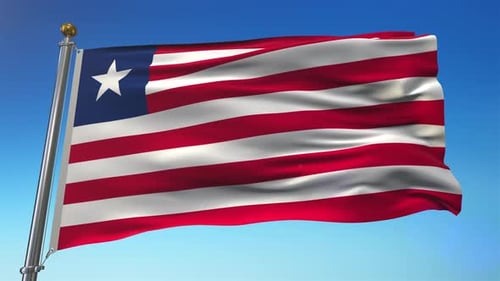 Waving Liberia National Flag on Flagpole Against Blue Sky